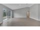 This spacious living room has tile floors, grey walls, and a sliding glass door at 41 Peterlee Ct, Kissimmee, FL 34758