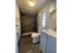 Bathroom featuring a walk-in shower with gray tiling and a vanity with a sink at 413 4Th St, Orlando, FL 32824