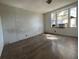 An empty bedroom featuring hardwood floors and a large window with natural light at 413 4Th St, Orlando, FL 32824