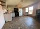 An open-concept living space and kitchen awaiting renovation at 413 4Th St, Orlando, FL 32824