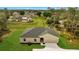 An overhead view of a single-story home highlighting its well-maintained landscaping at 43 Peterlee Ct, Kissimmee, FL 34758
