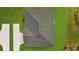 Aerial view of house showcasing gray roof, green grass, and a concrete driveway at 43 Peterlee Ct, Kissimmee, FL 34758