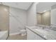 Bright bathroom featuring a granite vanity, toilet, and a white bathtub at 43 Peterlee Ct, Kissimmee, FL 34758
