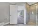 Bright bathroom featuring a glass shower and a view into a carpeted bedroom space at 43 Peterlee Ct, Kissimmee, FL 34758