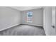 Bedroom with gray carpet, a window, and white trim, ready for personalization at 43 Peterlee Ct, Kissimmee, FL 34758