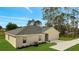Charming home with well-manicured lawn, gray roof, and a two car garage at 43 Peterlee Ct, Kissimmee, FL 34758