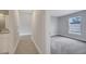 Hallway connecting a bathroom to a carpeted bedroom with a bright window at 43 Peterlee Ct, Kissimmee, FL 34758