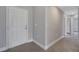 Entryway view with a white front door, leading to a hallway with tiled floors at 43 Peterlee Ct, Kissimmee, FL 34758