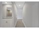 Hallway with tile flooring, leading to a bathroom with a granite vanity at 43 Peterlee Ct, Kissimmee, FL 34758