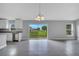 Bright kitchen and dining area with tile flooring and sliding glass door leading to the backyard at 43 Peterlee Ct, Kissimmee, FL 34758