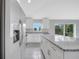 Bright kitchen with white cabinets, granite countertops, and stainless steel appliances at 43 Peterlee Ct, Kissimmee, FL 34758