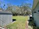 A well-maintained backyard includes a storage shed and partial views of the home's exterior at 430 Connecticut Ave, St Cloud, FL 34769