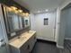 Beautifully renovated bathroom with double sinks, modern shower with recessed shelf and stylish tile at 430 Connecticut Ave, St Cloud, FL 34769