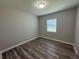 Cozy bedroom with natural light, wood-look flooring, and a neutral color scheme for a calming atmosphere at 430 Connecticut Ave, St Cloud, FL 34769