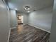 This bedroom offers wood flooring, neutral paint, natural light, and an ensuite bathroom at 430 Connecticut Ave, St Cloud, FL 34769
