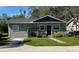 Charming single-story home with well-maintained lawn, gravel driveway, and neutral-toned siding at 430 Connecticut Ave, St Cloud, FL 34769