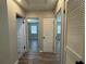 Bright hallway with modern flooring and neutral paint, leading to other rooms in the home at 430 Connecticut Ave, St Cloud, FL 34769