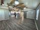 Open living space showcasing exposed beams, modern lighting, and a well-equipped kitchen with stainless steel appliances at 430 Connecticut Ave, St Cloud, FL 34769