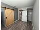 This room features wood flooring, modern barn doors, and recessed lighting at 430 Connecticut Ave, St Cloud, FL 34769