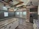 Open-concept living area with high ceilings, modern lighting, and wood-look flooring offers a spacious design at 430 Connecticut Ave, St Cloud, FL 34769