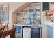 A bar area with stainless refrigerators is decorated with a nautical theme and beach decor at 4925 Poolside, St Cloud, FL 34769