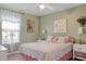 Light and airy bedroom with decorative lamps, floral bedding, and soft green walls at 4925 Poolside, St Cloud, FL 34769
