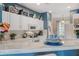 Bright kitchen with white cabinets, marble countertops, and stainless steel appliances at 4925 Poolside, St Cloud, FL 34769