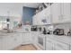 Bright kitchen with white cabinets, marble countertops, and stainless steel appliances at 4925 Poolside, St Cloud, FL 34769
