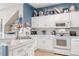 Bright kitchen with white cabinets, marble countertops, and stainless steel appliances at 4925 Poolside, St Cloud, FL 34769