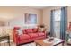 Comfortable living room featuring a red couch and tasteful decorations at 4925 Poolside, St Cloud, FL 34769
