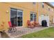 Cozy patio with red lounge chairs and a barbecue grill at 4925 Poolside, St Cloud, FL 34769