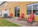 Outdoor brick patio with red seating offers relaxation and enjoyment at 4925 Poolside, St Cloud, FL 34769