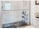 A modern shower with black hexagonal tile floors and white tiled walls is a beautiful upgrade at 4925 Poolside, St Cloud, FL 34769
