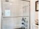 Modern tiled shower with glass doors and black honeycomb tile floor at 4925 Poolside, St Cloud, FL 34769