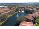 Aerial view of community featuring condos, a lake, a fountain, and a pool area surrounded by mature trees at 6153 Metrowest Blvd # 103, Orlando, FL 32835