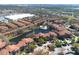 Extensive aerial view of a community with a lake, fountain, and lush landscaping at 6153 Metrowest Blvd # 103, Orlando, FL 32835