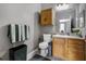 Bathroom featuring a wood vanity, a framed mirror, and green and white towels at 6153 Metrowest Blvd # 103, Orlando, FL 32835