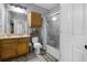 Full bathroom featuring a shower/tub combo, updated vanity and fixtures, and decorative shelves at 6153 Metrowest Blvd # 103, Orlando, FL 32835