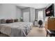 Comfortable bedroom with a large bed, a window with drapes, and a wooden dresser at 6153 Metrowest Blvd # 103, Orlando, FL 32835