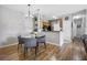 Cozy dining area features modern chandelier, seating for four, and luxury vinyl plank flooring at 6153 Metrowest Blvd # 103, Orlando, FL 32835