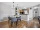 Cozy dining area features modern chandelier, seating for four, and luxury vinyl plank flooring at 6153 Metrowest Blvd # 103, Orlando, FL 32835