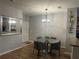 Dining area featuring hardwood floors and a glass table at 6153 Metrowest Blvd # 103, Orlando, FL 32835