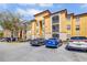 Well-maintained apartment building exterior featuring a stucco facade, covered balconies, and convenient parking at 6153 Metrowest Blvd # 103, Orlando, FL 32835