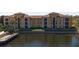Beautiful lakeside view of a building with a red tile roof and multiple windows at 6153 Metrowest Blvd # 103, Orlando, FL 32835