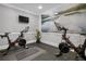 Fitness center featuring two Peloton bikes, a large wall mural, and rubber flooring at 6153 Metrowest Blvd # 103, Orlando, FL 32835
