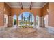 Lovely courtyard view of a stone fountain with yellow flowers surrounded by arched columns at 6153 Metrowest Blvd # 103, Orlando, FL 32835