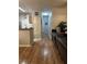 Inviting hallway with plank flooring, neutral walls, and convenient access to kitchen at 6153 Metrowest Blvd # 103, Orlando, FL 32835