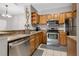 This updated kitchen features stainless steel appliances, light brown cabinetry, and modern countertops at 6153 Metrowest Blvd # 103, Orlando, FL 32835