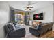 Cozy living room featuring a sliding glass door to a balcony and wood plank flooring at 6153 Metrowest Blvd # 103, Orlando, FL 32835