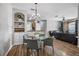 Open floor plan featuring a dining area, kitchen, and living room with hardwood flooring at 6153 Metrowest Blvd # 103, Orlando, FL 32835